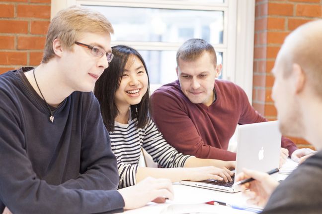 RS1404__MG_9583-lpr.jpg Eine Gruppe Studierender lernt und diskutiert gemeinsam in der Mensa.