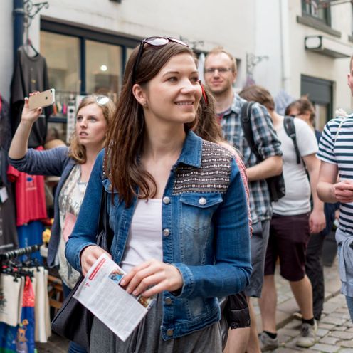 Junge M&auml;nner und Frauen laufen durch die Stadt