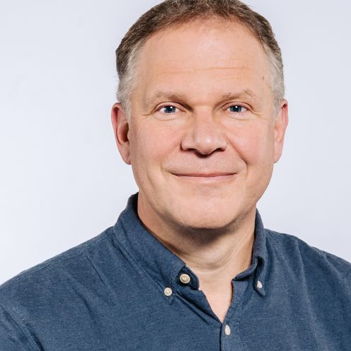 Auf dem Bild ist Christian Spatscheck zu sehen. Er hat kurzes braunes Haar und tr&auml;gt ein blaues Hemd. 