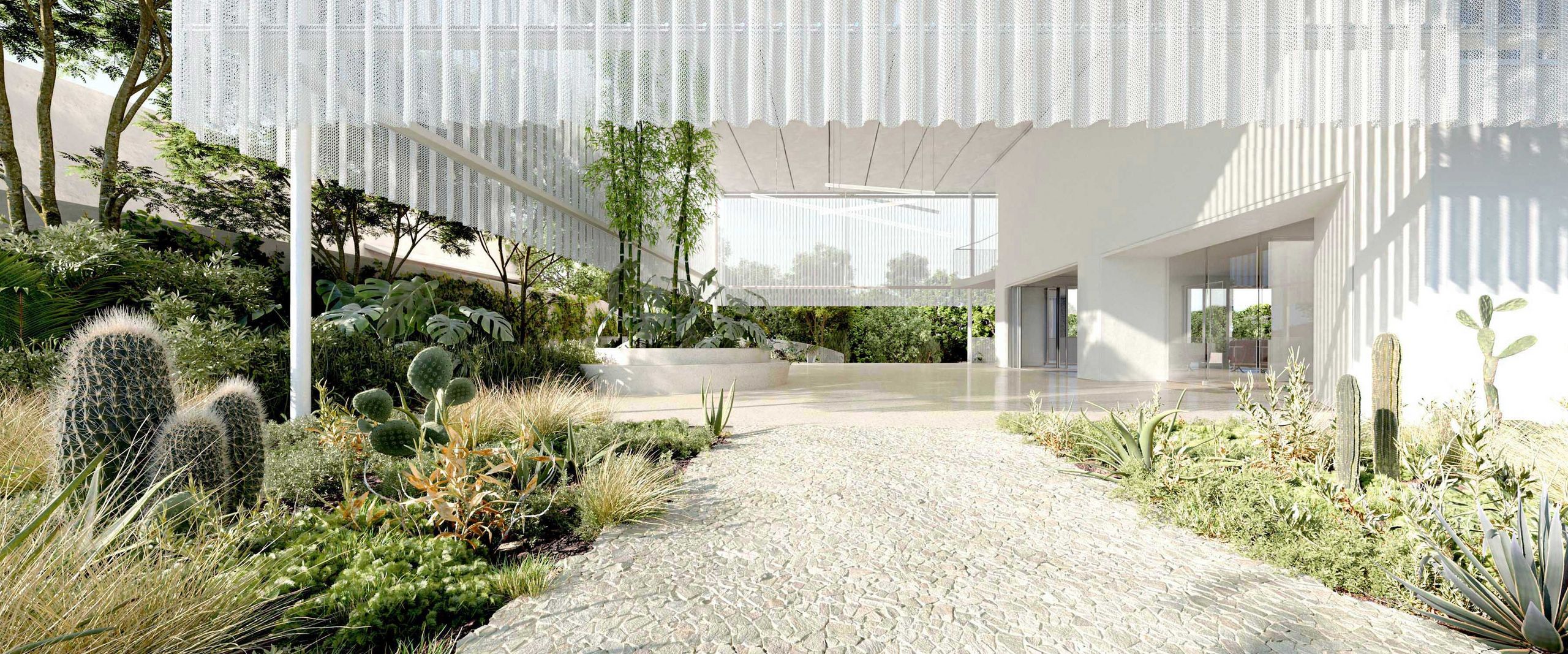 Das Bild zeigt den Ausschnitt eines modernen, weißen Gebäudes mit Weg und Grünbepflanzung am Rande