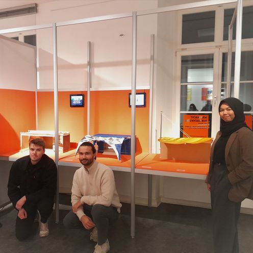 Drei M&auml;nner und eine Frau vor Architekturmodellen