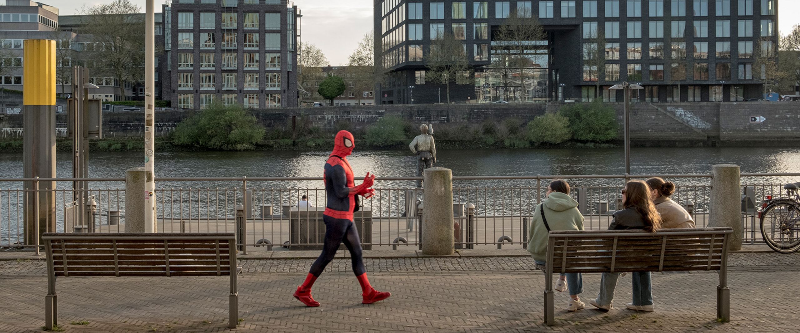 Living Sea Front Press Photo Man in a Spider-Man costume walks along the Weser promenade in Bremen.