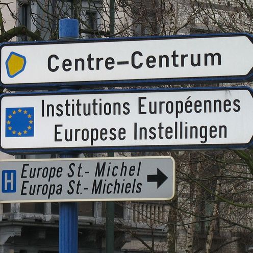 Stra&szlig;enschilder in Br&uuml;ssel, insgesamt 3 &uuml;bereinander, in der Mitte steht zu den Europ&auml;ischen Institutionen
