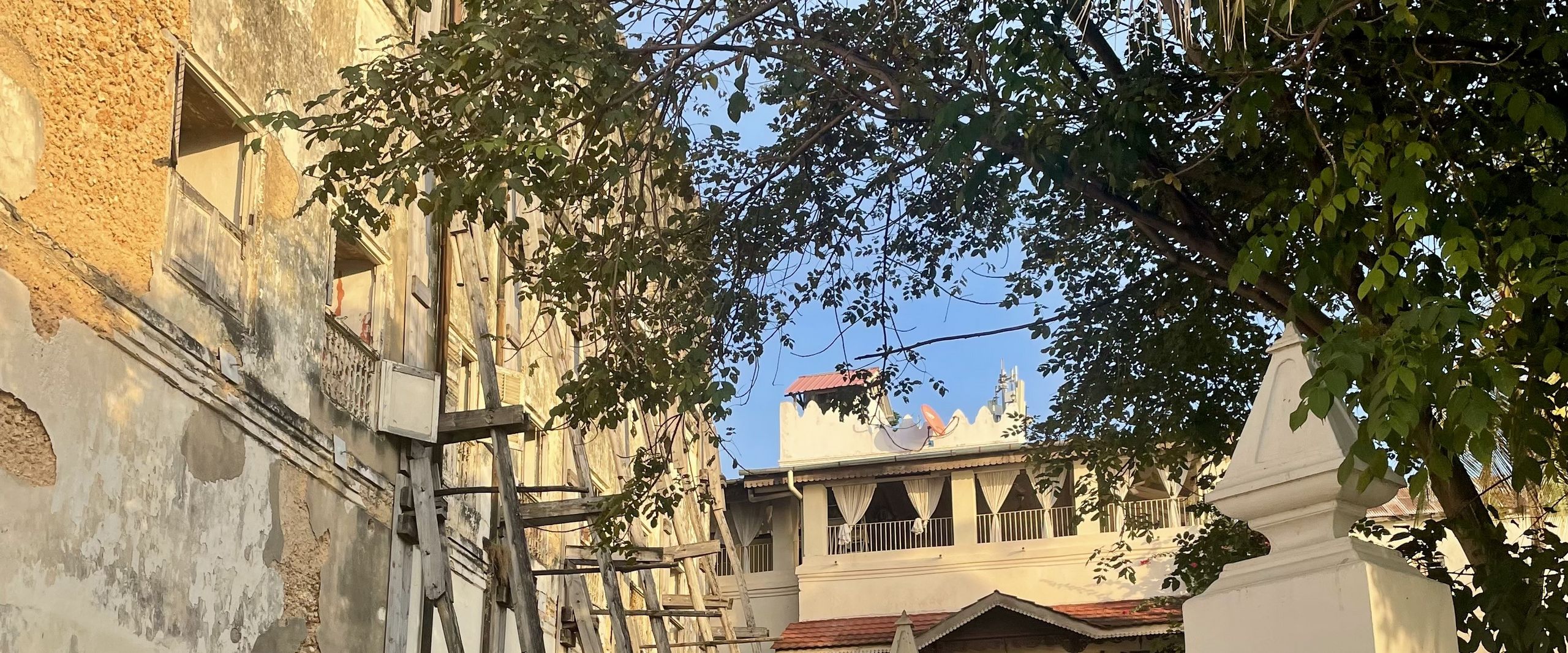 Stone houses, some of which are supported by wooden posts 