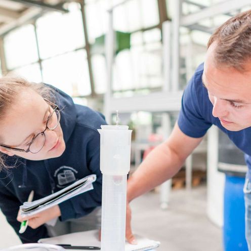 Zwei Schiffbaustudierende arbeiten an einem Versuchsaufbau.