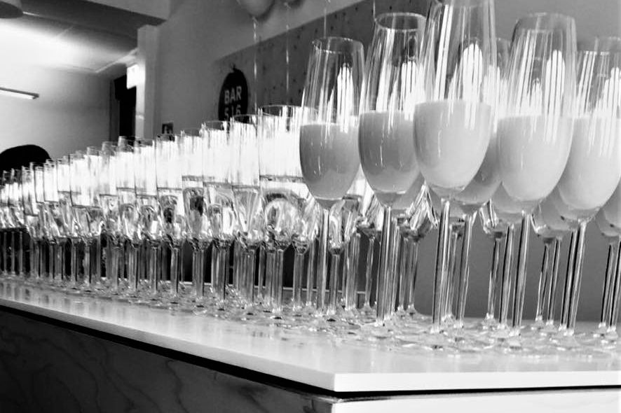 Bar516 6 Gefüllte Sektgläser auf einer Bar.