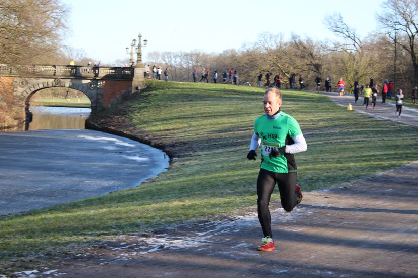 Ein L&auml;ufer rennt an einem Fluss vorbei.