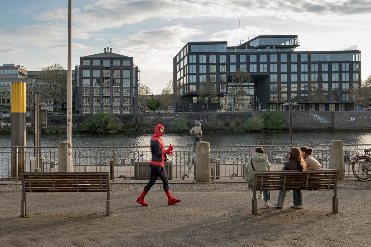 Mann im Spider-Man-Kost&uuml;m l&auml;uft an der Weserpromenade in Bremen entlang.