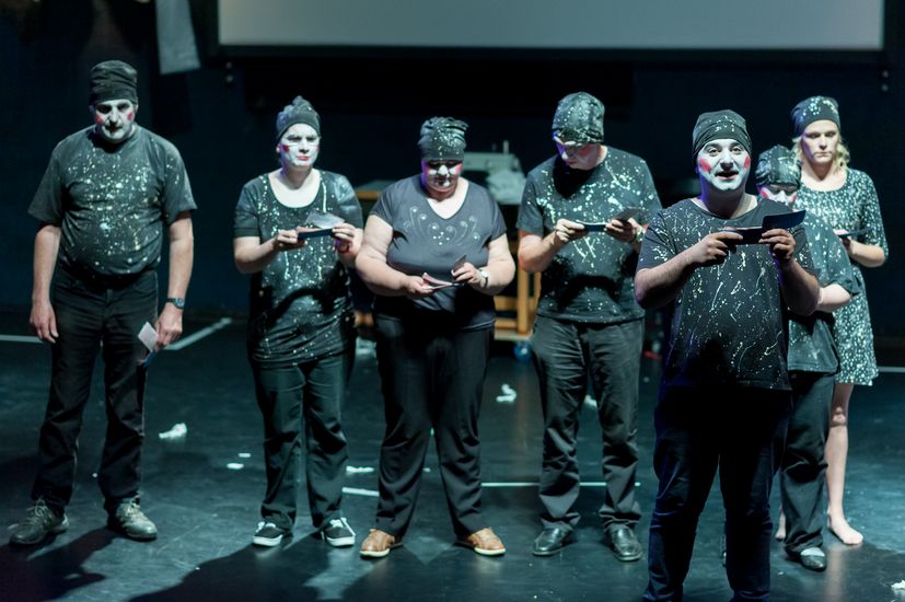 Bühnenszene aus dem Theaterstück "Peer Gynt" mit einer Gruppe Studierender.