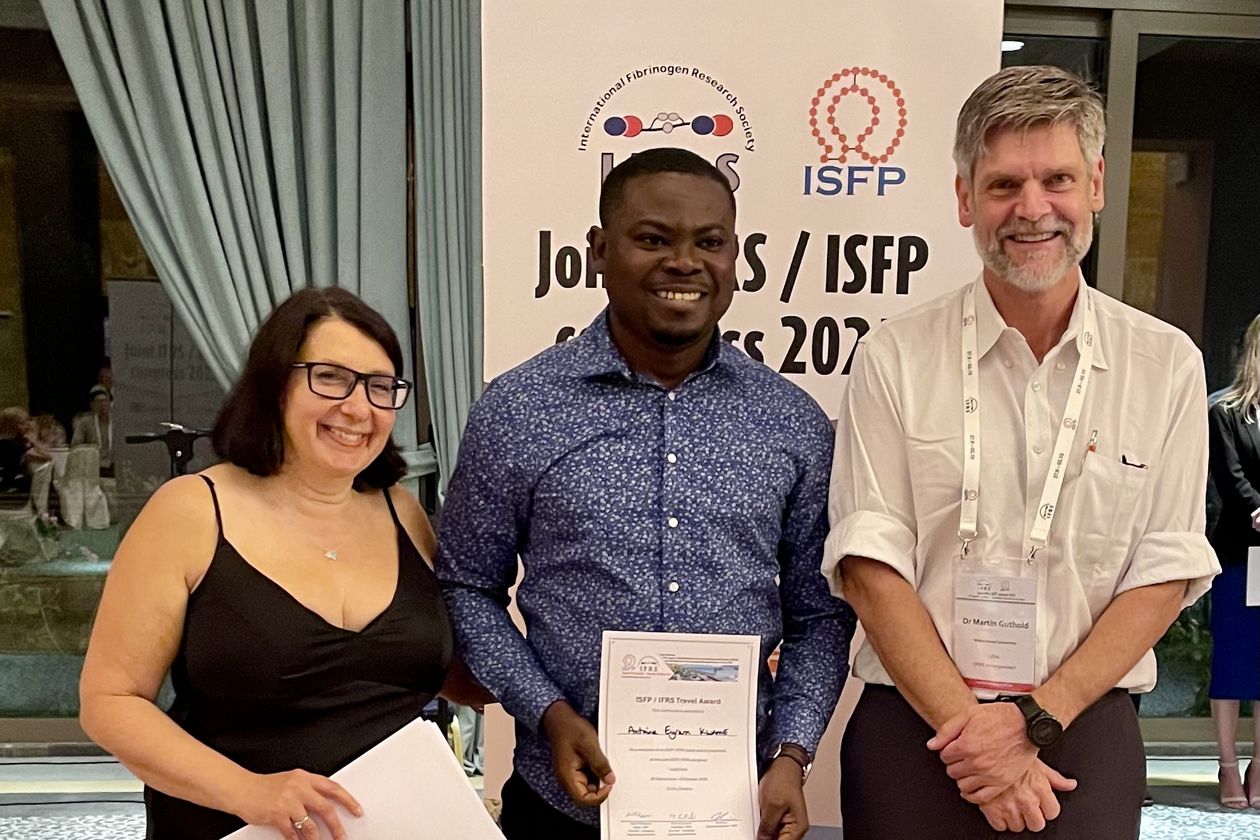 Gruppenfoto von Kwame mit zwei Professor:innen