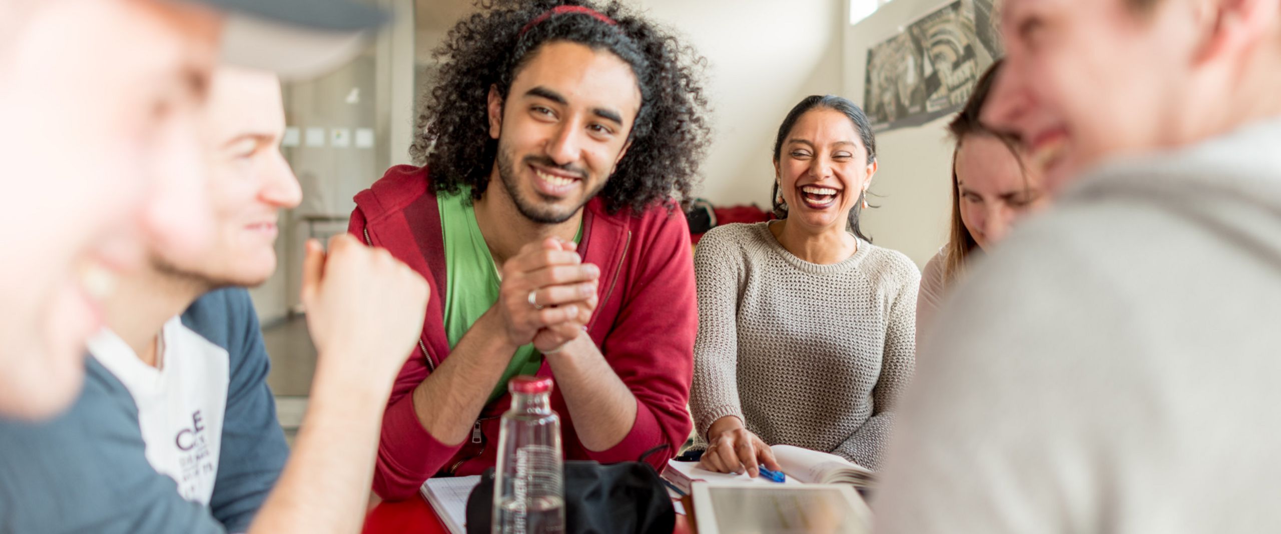 Eine Gruppe Studierender sitzt an einem Tisch und lernt gemeinsam.