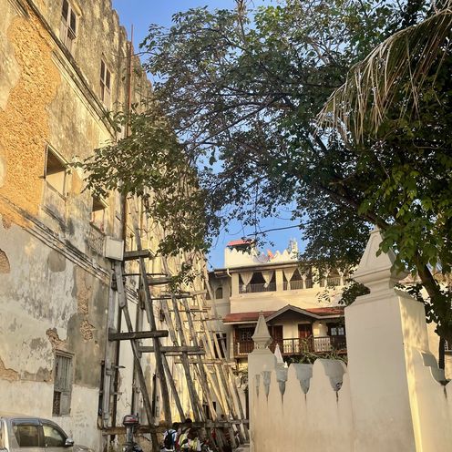 Stone houses, some of which are supported by wooden posts 