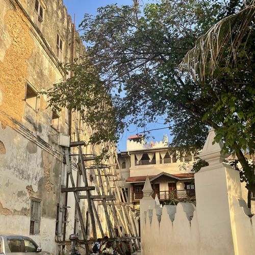 Stone houses, some of which are supported by wooden posts 