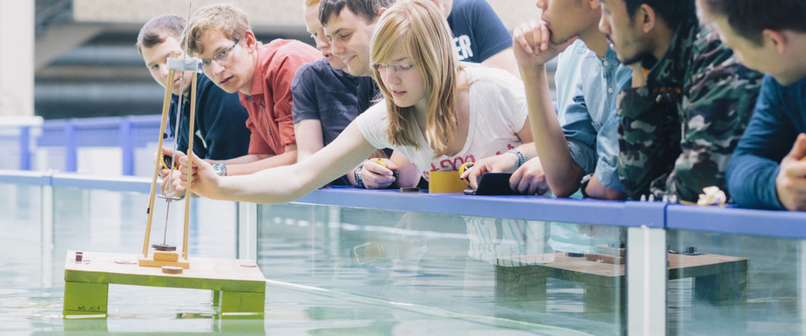 Wasserbecken Studierende stehen zusammen vor einem Wasserbecken.