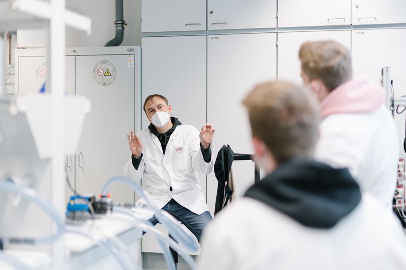 Zwei Studierende sitzen im ISU-Strömungslabor mit der Professorin.