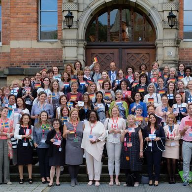 More than one hundred conference participants standing in front of the university